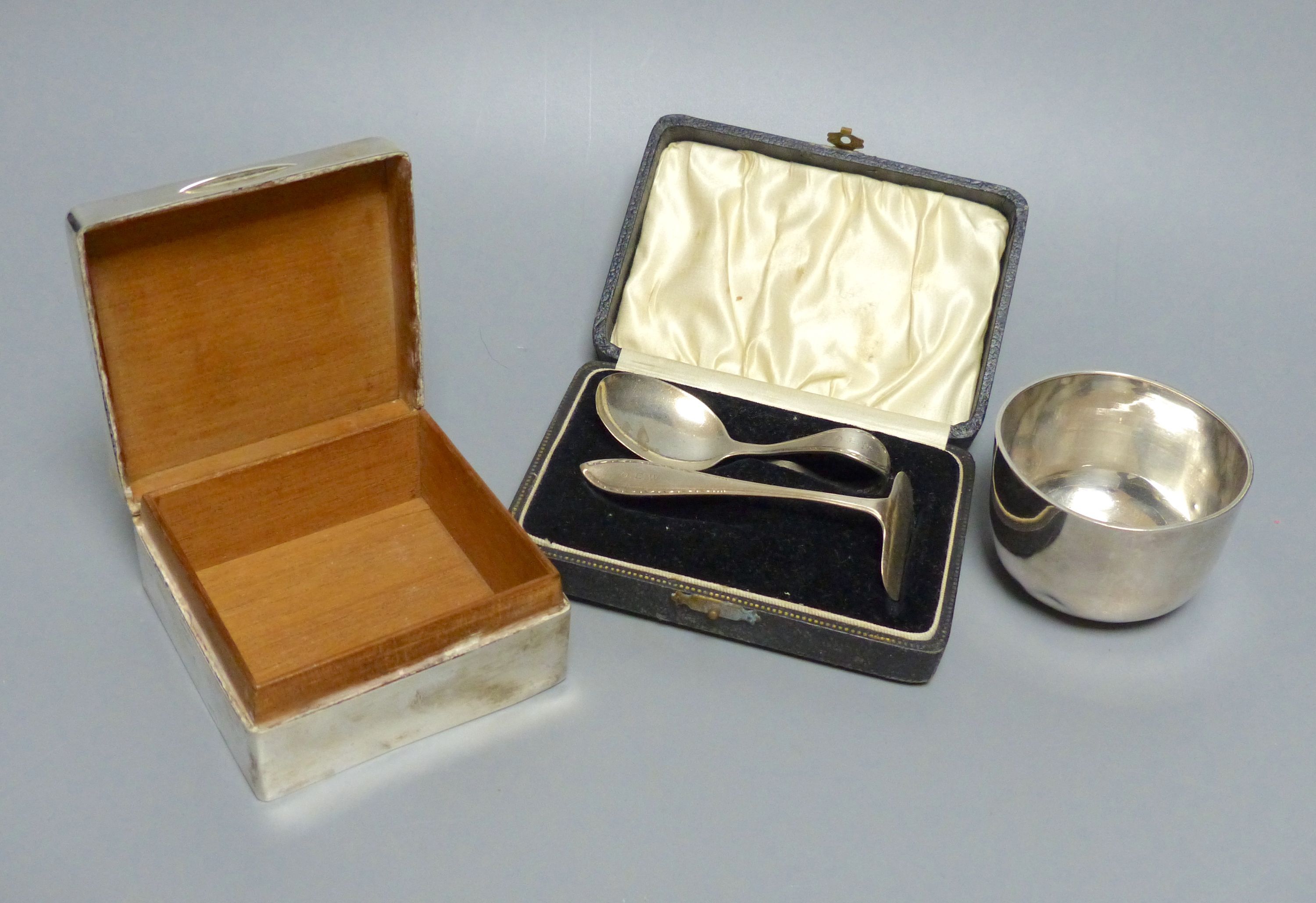 A sterling goblet, silver cigarette box, small beaker and cased spoon & pusher.
